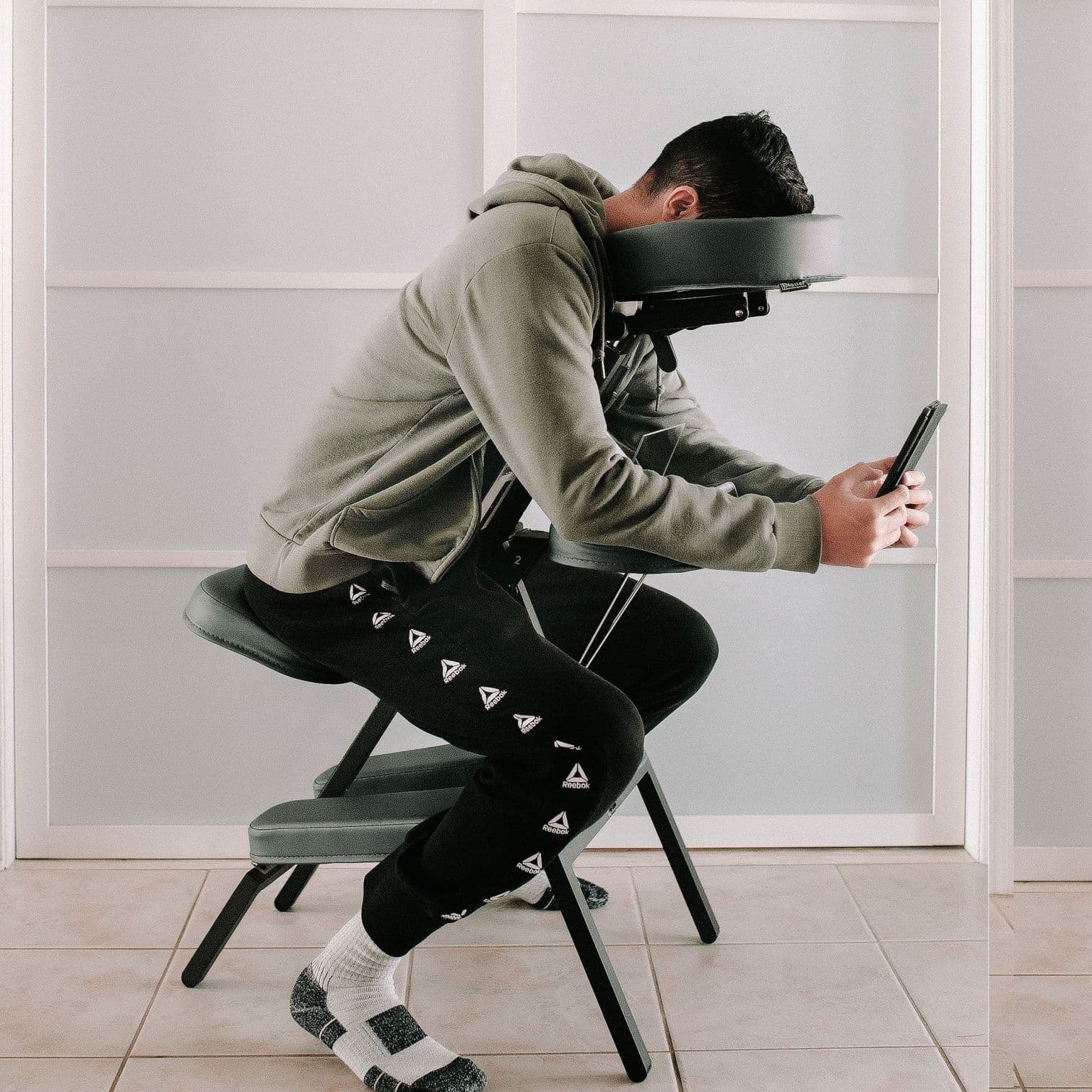 Patient using a face down recovery chair during vitrectomy recovery at home